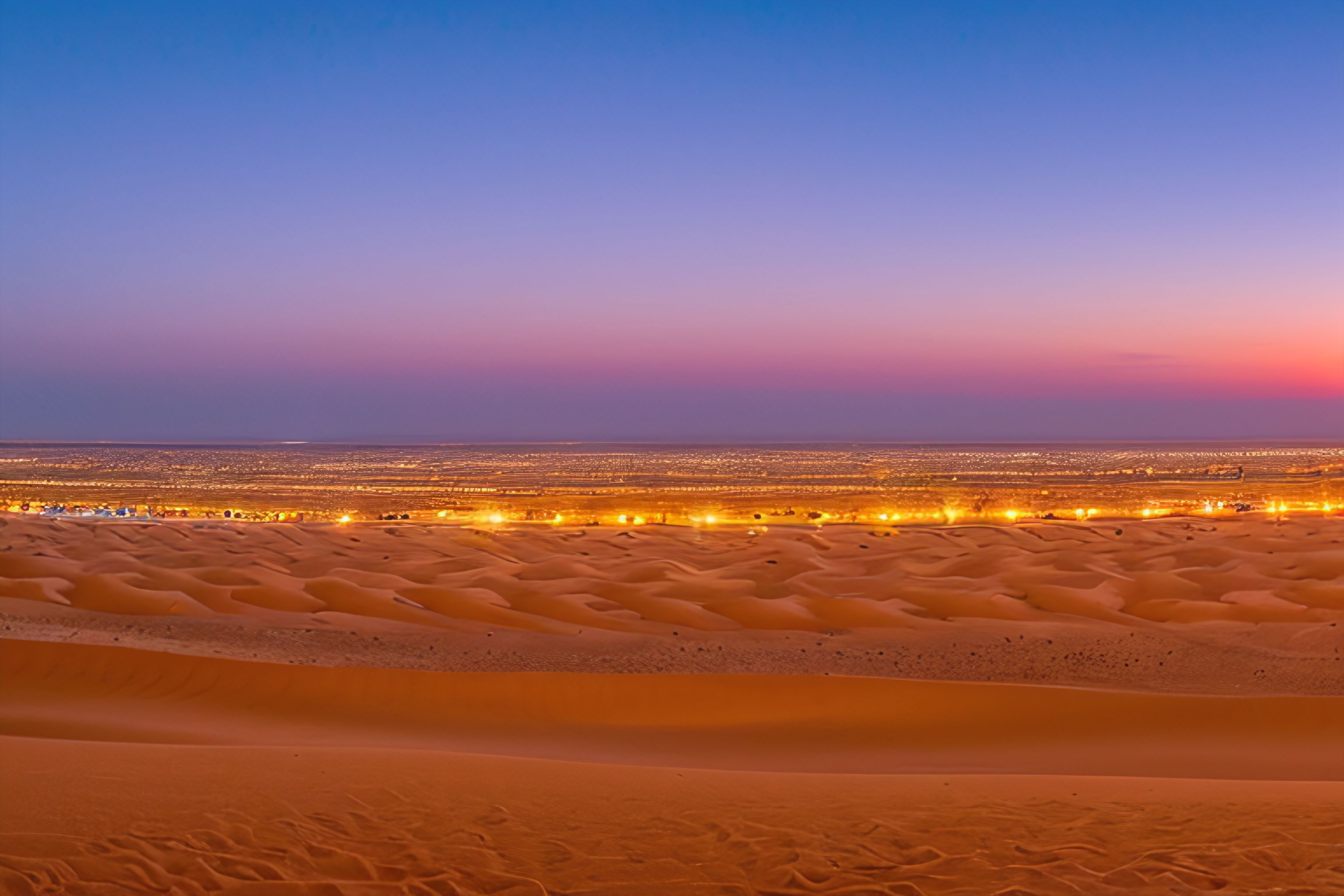 A panoramic view of the Kuwaiti desert at dusk.
