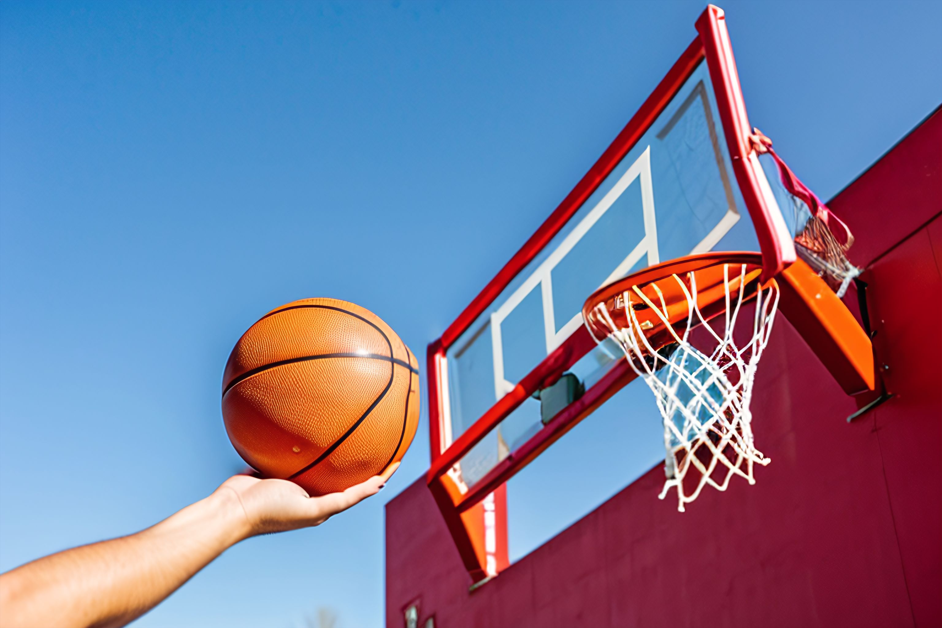 A basketball in mid-air, about to go through a hoop