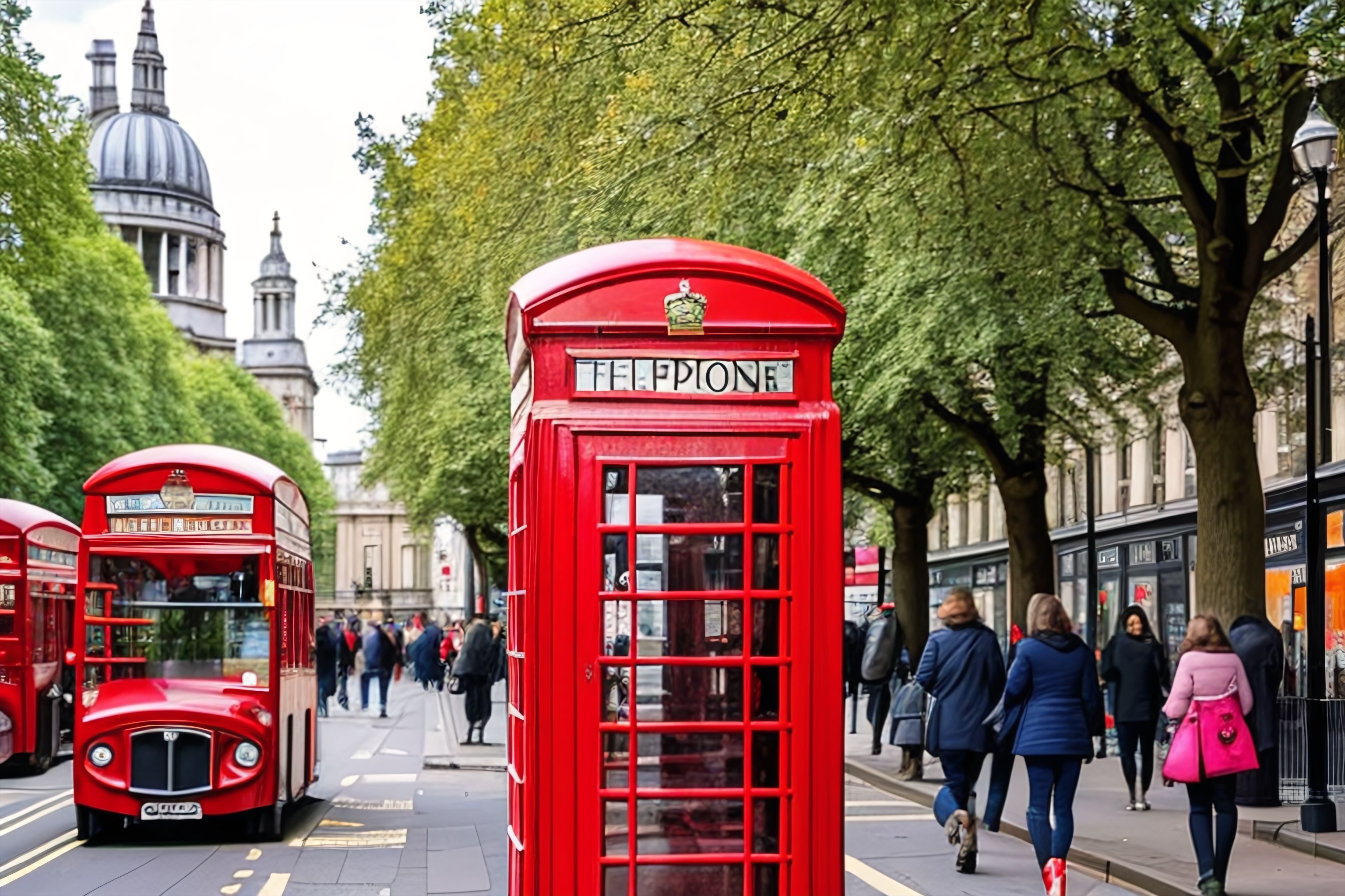 A busy London street with iconic red phone booths and a double-decker bus in the background.