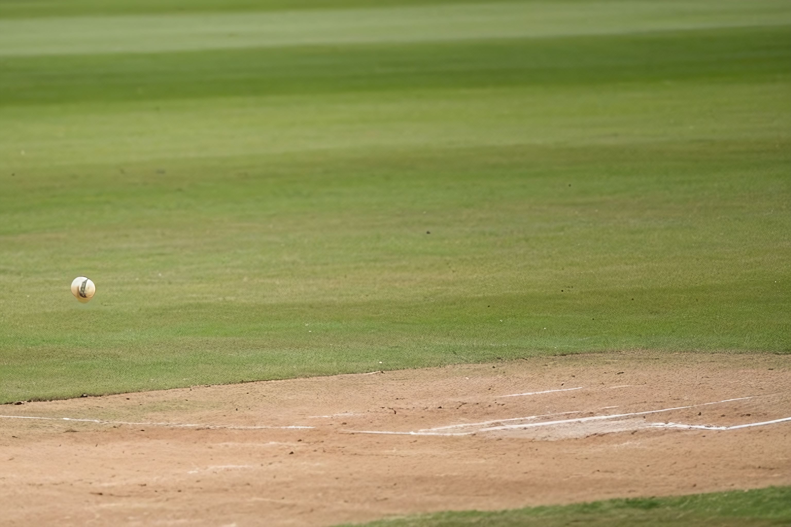 A cricket ball flying through the air towards a batsman